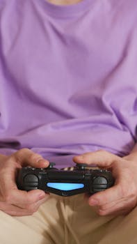 Close-up of hands holding a wireless game controller, perfect for gaming themes.